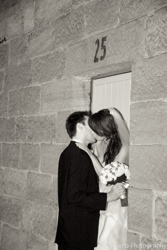 Couple kissing in an old sandstone doorway the rocks sydney - wedding photography sydney